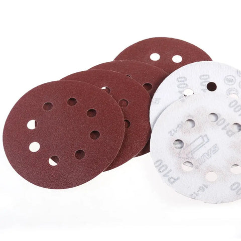 Super Tough 5 Inch Hook And Loop Sanding Discs With Eight Holes For Dustless Vibes, showing red and white sanding discs for surface conditioning.