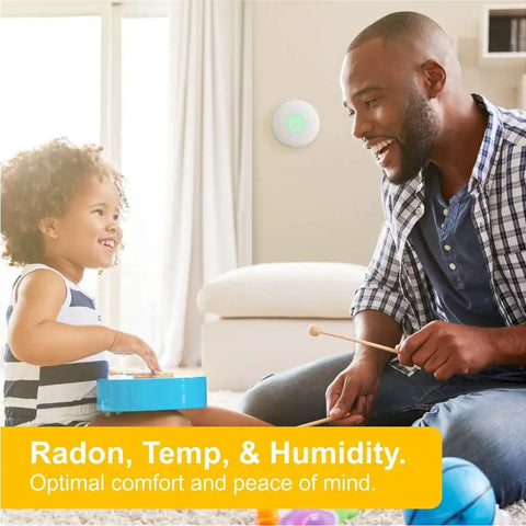 Family in a living room with Smart Radon Detector With Humidity And Temperature Sensor on wall, home safety focus.