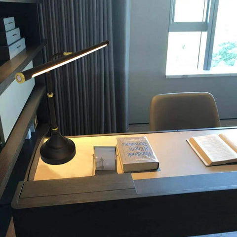 Wide 21.26 Inch Piano Lamp With LED Light Panel on a desk in home office, black and gold finish, adjustable height, eye-caring