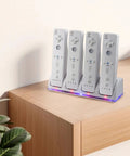 4 In 1 Game Controller Charging Station With Four Rechargeable Battery Packs And USB Cable, controllers docked on a desk