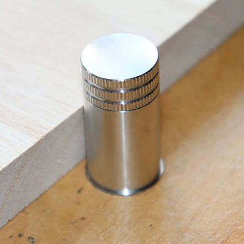 Close-up of Stainless Steel Bench Dog Set 20mm for MFT Workbenches with T Track Connectors on wooden table