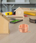 RC Boat Water Cooling Ring Kit For Brushed Motors Copper Cooling Jacket on a workbench with DIY tools and wooden model houses