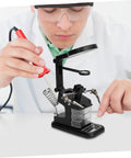 Person using a rechargeable USB welding clip light with magnifier for soldering on workbench, bright LED, adjustable beam.