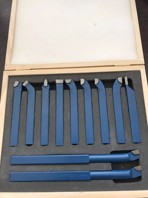 Top Shelf 11 Piece Tungsten Carbide Lathe Turning Tool Set With Heavy Duty Boring Bars And Roughing Grooving Inserts Built Tough for mini lathe work, displayed in a wooden case.