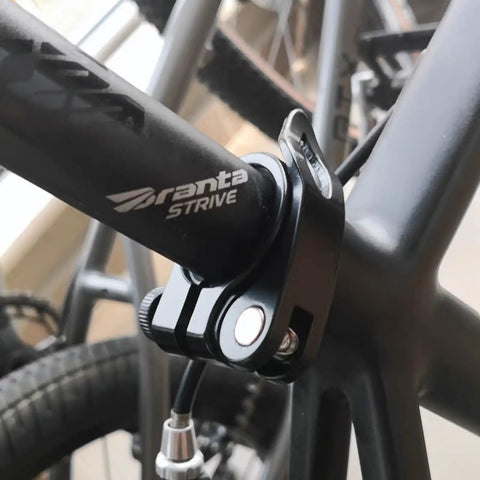 Close-up of Beefy Aluminum Alloy Bike Seat Post Clamp With Quick Release on black bike frame, showing retaining bolt and fit