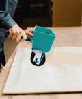 Heavy Duty Wood Glue Roller Applicator Featuring Smart Flow Control Dial in use on wood surface for even glue application.
