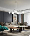 Matt Black Sputnik Chandelier Five Light Pendant, mid-century modern, in a stylish living room, height adjustable with two rods.