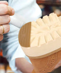 Person applying Polyurethane Shoe Heel Repair Pads Half Round Sole Protectors For Sneakers on shoe sole.