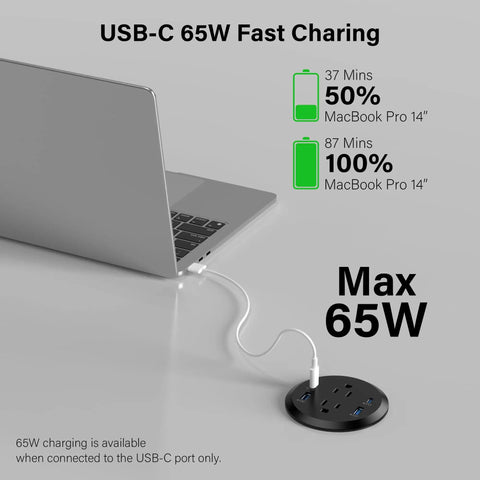 Sleek Flush Mount Power Grommet Featuring Four Standard Outlets And Four USB C Fast Charging Ports For Your Next Big Boss Setup and Countertop Organization Game Changer For Modern Home Office Black Dual Sided Design Six Foot Cord charging a MacBook Pro.