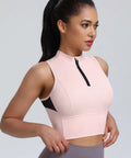 Woman wearing cropped workout tank for women with built in bra half zip high neck sports top medium support sleeveless athletic tank