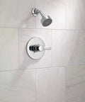 Matte Black 6-Function Shower Head Trim Kit With Pause Setting, on white tiled bathroom wall