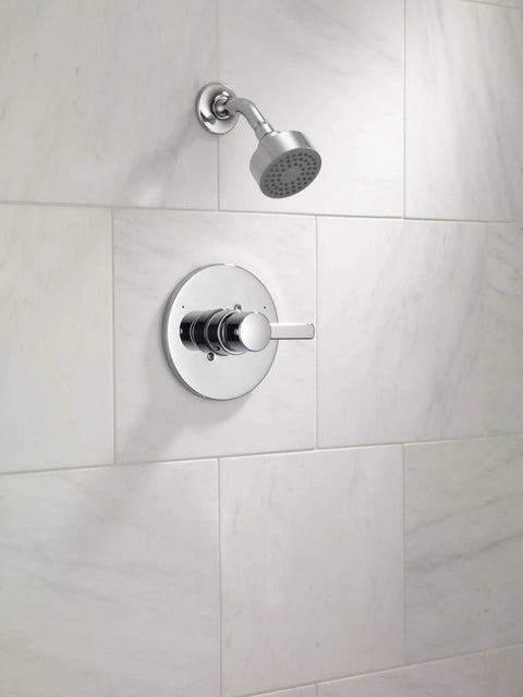 Matte Black 6-Function Shower Head Trim Kit With Pause Setting, on white tiled bathroom wall