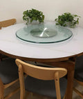 Glass Lazy Susan Turntable With 360 Degree Swivel Rock Solid Heavy Duty Aluminum Base on dining table with chairs.