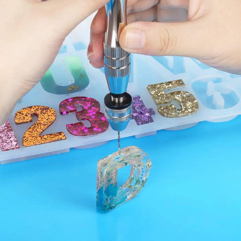 Using Killer Precision Steel Pin Vise Hand Drill with mini drill bit on resin letter D for crafting and DIY projects.