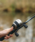Close-up of Go-To Spincast Reel And Telescopic Fishing Rod Combo With Extendable 22.5-Inch To 6-Foot E-Glass Pole Size 30 Reel in use