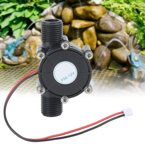 Micro Hydroelectric Water Generator 12V 10W Turbine with vorticity impeller, black housing, wires attached, garden background
