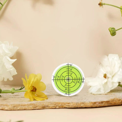 4 Pack Mini Bubble Level Tool Set For Quick High-Precision Measurements portable round spirit level on stone surface with flowers