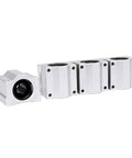 Side view of four silver aluminum SCS16UU linear motion bearing blocks with 16 mm bore