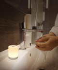 Touch Night Light For Nursery And Bedroom Cordless Battery Powered Dimmable Lamp next to bathroom sink with hands under running water