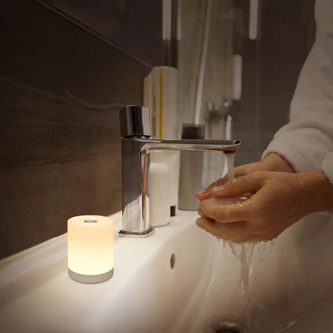 Touch Night Light For Nursery And Bedroom Cordless Battery Powered Dimmable Lamp next to bathroom sink with hands under running water