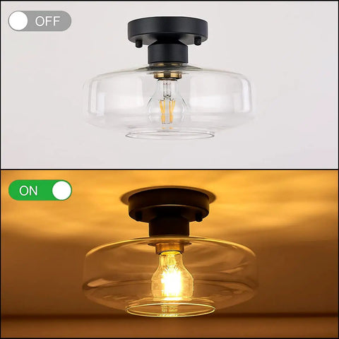 Matte Black Flush Mount Ceiling Light With Clear Glass Shade, brass accent, shown off and illuminated, modern vintage style