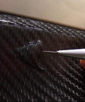 Slick Retractable Awl And Air Release Needle No Fuss Carbon Steel Scribe For Vinyl Weeding Cricut Crafting, detailing a bubble on vinyl.