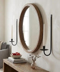 Super Rock Solid Iron Wall Candle Sconces Set Of Two Matte Black Metal Hanging Mount beside round mirror in farmhouse decor.