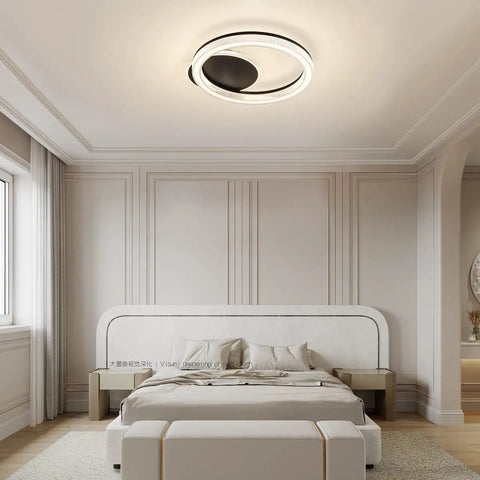White Finish Modern Flush Mount Circle Ring LED Ceiling Light With Three Color Temperature Settings For Living Room Bedroom And Restaurant Acrylic Ring Fixture Sleek Yet Bright Ambience installed in a modern bedroom