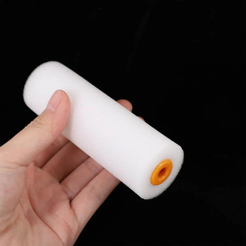 10 Pack High Density Foam Paint Roller Covers for Walls Ceilings Cabinets and Doors Achieve a Hella Smooth Finish on Flat Surfaces with Multi Purpose Replacement Roller Sleeve held in hand.