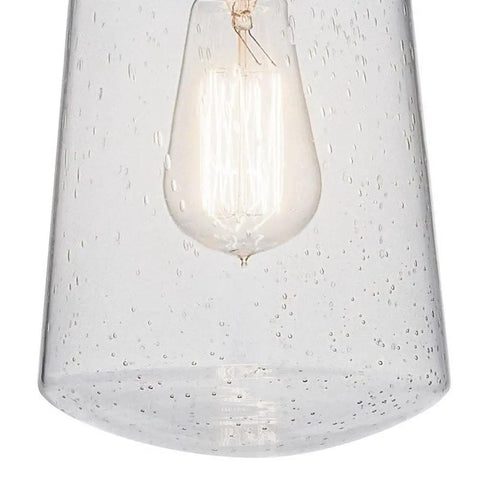 Close-up of Lyndon 11.75 Inch One Light Pendant in Architectural Bronze With Clear Seeded Glass, showing vintage filament bulb