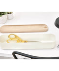 Recycled Plastic Drawer Organizer Bin With Paulownia Wood Lid, Ultra Compact 3.6 By 14.4 By 2.4 Inches, Coconut Finish on desk.