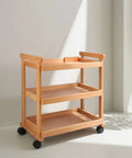 Sturdy Beech Wood Rolling Art Supply Cart With Wide Three Tier Shelves Secure Side Guards And Silky Smooth Wheels in a bright studio.