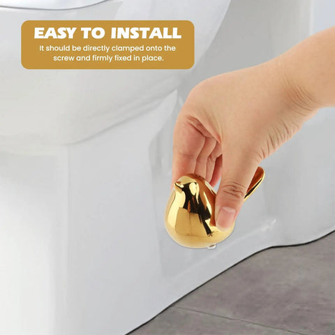 Two Piece Gold Ceramic Bird Toilet Bolt Covers Snazz Up Your Bathroom By Hiding Ugly Base Bolts With Cute Screw Caps That Bring Fresh Decor Vibes And Make Easy Installation A Breeze For Any Home Setup, shown in hand for easy installation.