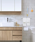 Self Adhesive Bathroom Hardware Set With 16 Inch Towel Bar Toilet Paper Holder And 3 Towel Hooks SUS304 Stainless Steel Wall Mount No Drill Stick On Kit For Easy Install Durable Rustproof Finish in a modern white tiled bathroom