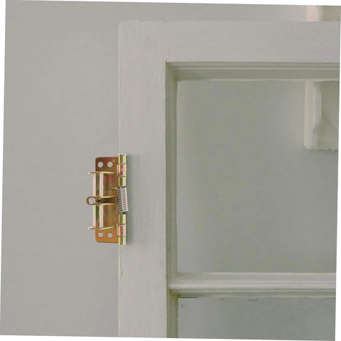 Heavy duty cabinet hinges on a white wooden door for durability and smooth operation.