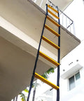 13 Ft Rope Emergency Ladder For Two Story Homes Foldable Portable Balcony Escape attached to second floor balcony in sunlit area