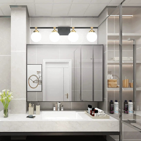 Four Light Mid Century Modern Bathroom Vanity Light Fixtures Over Mirror In Black And Gold With Milk White Glass Globes Wall Mount Vanity Lighting For A Warm Luxe Bath Updated Look, installed in elegant bathroom setting.
