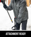 User holding the Badass Brushless 40 Volt Cordless Snow Shovel Kit preparing to use the attachment in snow.
