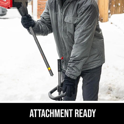 User holding the Badass Brushless 40 Volt Cordless Snow Shovel Kit preparing to use the attachment in snow.