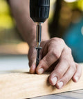 Person installing Heavy Duty Outdoor Deck Screws 14 By 2 And A Half Inch, 44 Pack, Black Epoxy Coated using a drill on wood