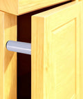 Close-up of Smooth As Butter Push To Open Cabinet Latches installed in wooden cabinetry, showcasing gray mechanism and clean lines.