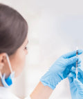 1 Ml Syringe With 31G Five Sixteenth Inch Needle Pack Of 30 Individually Wrapped Lab Tools For Quick Readouts And A Smooth Plunger Clear Scale And Airtight Inner Wall Perfect For Lab Work Medical Demos Or At Home Experiments. gloved hand holding 1 mL syringe with scale