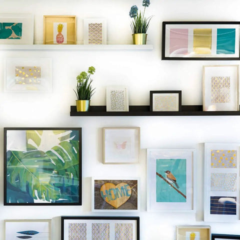 Gallery wall with various framed art, showcasing Picture Hanging Tool With Built In Level For An Easy No Fuss Frame Hanger Kit On Walls