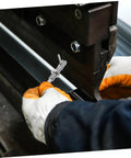 Hand using Top Shelf Stainless Steel L Handle Spring Plunger Pin Knockout Security Lock on a tool assembly line.