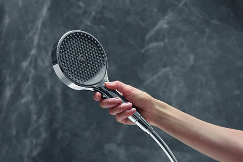 Hand holding Rainfinity 5-Inch Handheld Shower Head With Three Spray Modes PowderRain Intense PowderRain MonoRain Chrome Finish