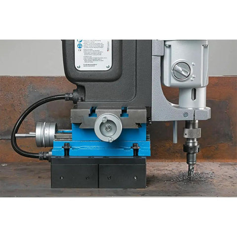 Rock Solid Workhorse Portable Magnetic Mill Drill With Adjustable Base Variable Speed Four Gear Drive Reversible Motor and Power Assist for Flawless Shop Floor Work on a steel surface.