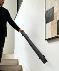 Flush Wall Mount Stair Handrail Heavy Duty Stainless Steel Safety Rail Sleek Modern Black Profile being held on stairs.