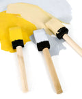 Kick Ass 1 Inch Foam Paint Brushes 12 Pack High Density Polyfoam Applicators For Mod Podge Wood Staining Wall Decor Awesome Household Cleanup Tasks Zero Hassle. Close-up of three foam brushes in yellow, white, and beige paint.