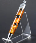 Top Shelf Chrome Woodturning Hardware Kit Pencil And Pen Project Set Three Piece Collection displaying a chrome pen on a clear stand.