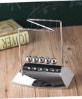 Z Shape Newton Cradle Pendulum Desk Toy For Home Office Decor with silver finish and five-ball design on a wooden desk